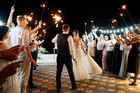 newlyweds at a wedding in the corridor of sparklersの写真素材