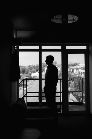 portrait of groom in blue three piece suit on wedding day in hotelの写真素材