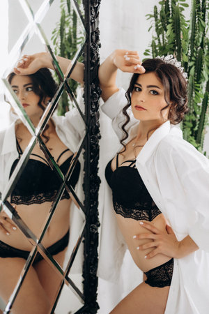 black-haired bride girl getting ready for groom in boudoir with bathの写真素材