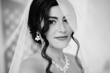 black-haired bride girl getting ready for groom in boudoir with bathの写真素材