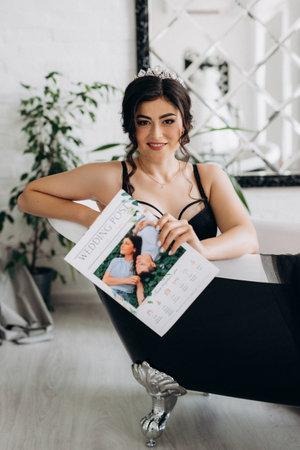 black-haired bride girl getting ready in boudoir with bathの写真素材