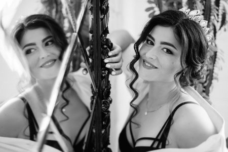 black-haired bride girl getting ready for groom in boudoir with bathの写真素材