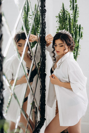 black-haired bride girl getting ready in boudoir with bathの写真素材