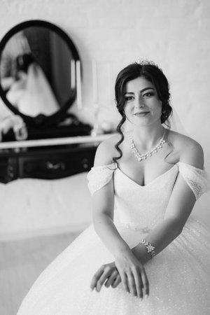 black-haired bride girl getting ready for groom in boudoir with bathの写真素材