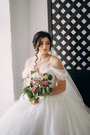 black-haired bride girl getting ready for groom in boudoir with bath