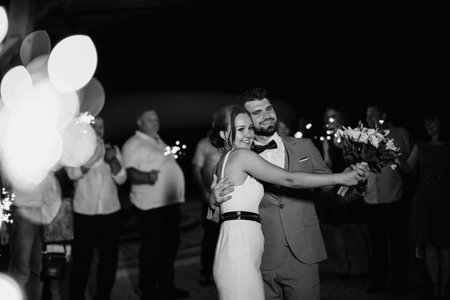 newlyweds at a wedding in the corridor of sparklersの写真素材