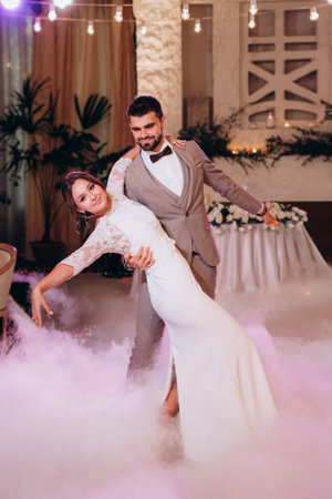 the first dance of the bride and groom inside a restaurantの写真素材