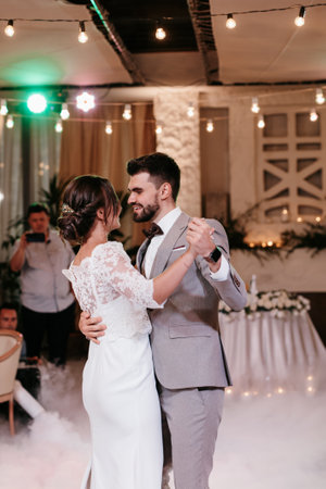 the first dance of the bride and groom inside a restaurantの写真素材