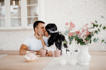 young couple guy and girl in a large kitchen in the morningの写真素材
