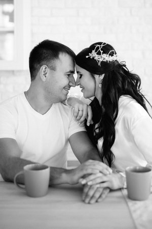 young couple guy and girl in a large kitchen in the morningの写真素材