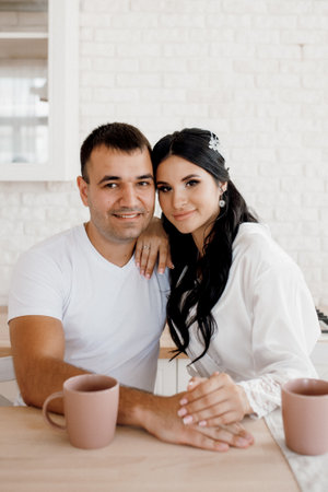 young couple guy and girl in a large kitchen in the morningの写真素材
