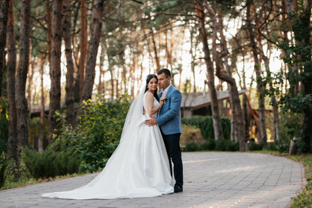 the first meeting of the bride and groom in wedding outfits in the parkの写真素材