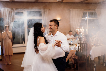 the first dance of the bride and groom inside a restaurantの写真素材
