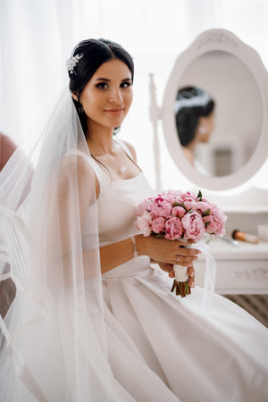 brunette bride in a wedding dress in a bright studioの写真素材