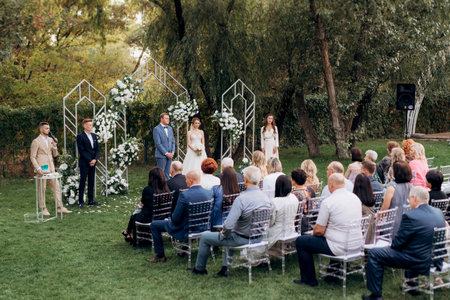 wedding ceremony of the newlyweds on the glade near the restaurantの写真素材