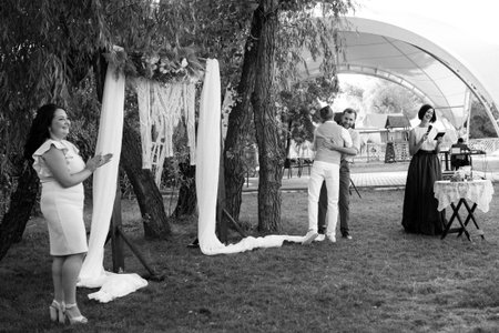 wedding ceremony of a young couple in love on a green meadowの写真素材
