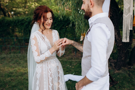 wedding ceremony of a young couple in love on a green meadow in the forest