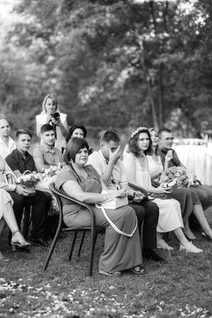 wedding ceremony of a young couple in love on a green meadow in the forestの写真素材