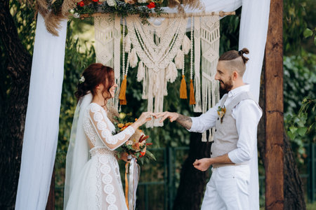 wedding ceremony of a young couple in love on a green meadow in the forestの写真素材