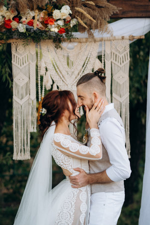 wedding ceremony of a young couple in love on a green meadow in the forestの写真素材
