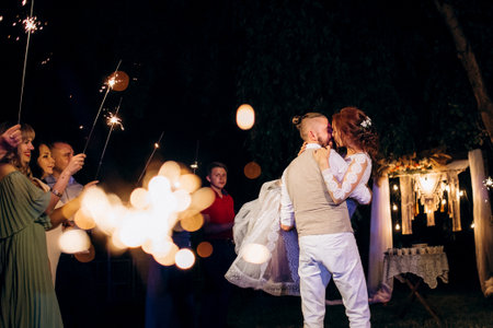 newlyweds at a wedding in the corridor of sparklers