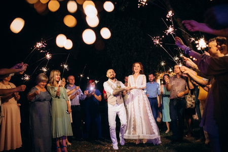 newlyweds at a wedding in the corridor of sparklers