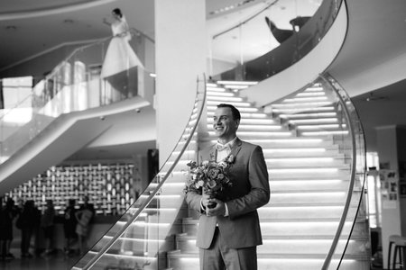first meeting of the bride and groom on the hotel stairsの写真素材