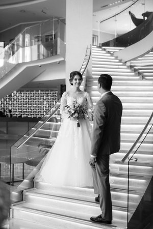 first meeting of the bride and groom on the hotel stairsの写真素材