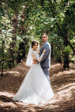 portrait of a groom and a bride in a deciduous forestの写真素材