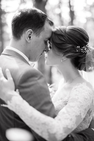 portrait of an elegant couple in a deciduous forestの写真素材