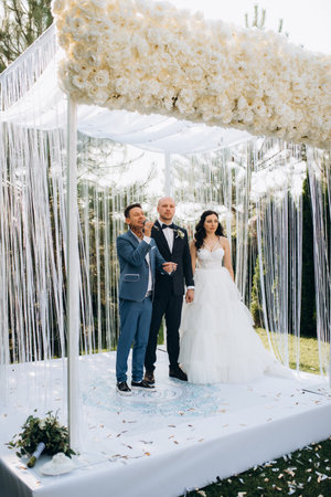 The newlyweds outdoor wedding ceremony in an open-air near the restaurantの写真素材