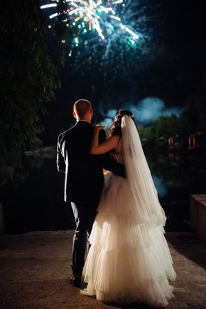 fiery pieces of a show against a dark sky and thunderstormsの写真素材