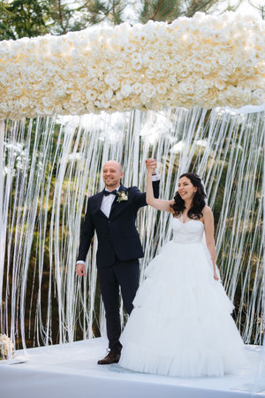 The newlyweds outdoor wedding ceremony in an open-air near the restaurantの写真素材