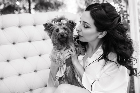 black-haired bride prepares for her wedding in a boudoir in the gardenの写真素材