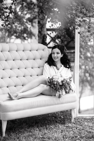 black-haired bride prepares for her wedding in a boudoir in the gardenの写真素材