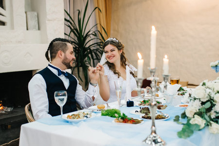 portrait of the newlyweds at the presidium at the wedding banquet