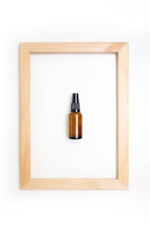 composition natural cosmetics lotion and wooden frame white background top viewの写真素材