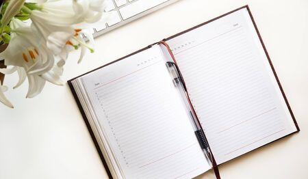 Open Notepad, a bouquet of lilies on a white backgroundの写真素材