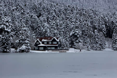 House on the edge of a frozen lake.