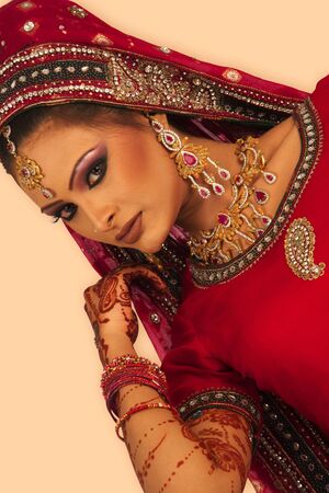 Slim beautiful woman wearing luxurious wedding dress over white studio backgroundの写真素材