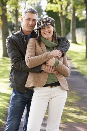 Portrait Of Romantic Couple Enjoying Outdoor Walk Through Autumn Parkの写真素材