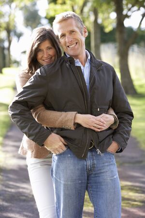 Portrait Of Romantic Couple Enjoying Outdoor Walk Through Autumn Parkの写真素材