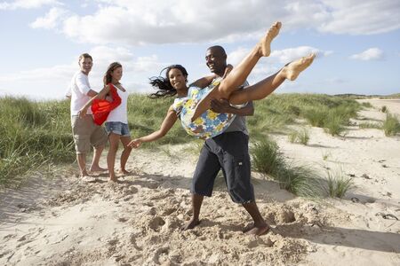 Group Of Young People Having Fun Dancing On Beach Togetherの写真素材
