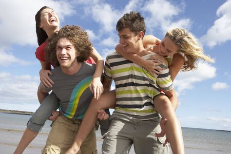 Group Of Young Friends Having Fun On Summer Beach Togetherの写真素材