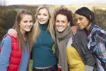 Group Of Four Teenage Female Friends In Autumn Landscapeの写真素材
