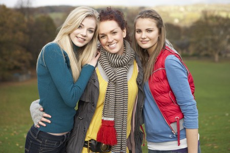 Group Of Three Teenage Female Friends In Autumn Landscapeの写真素材