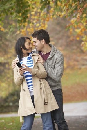 Romantic Teenage Couple In Autumn Parkの写真素材