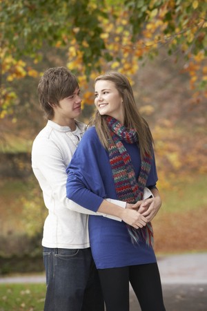Romantic Teenage Couple In Autumn Parkの写真素材