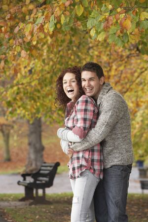 Romantic Teenage Couple In Autumn Parkの写真素材
