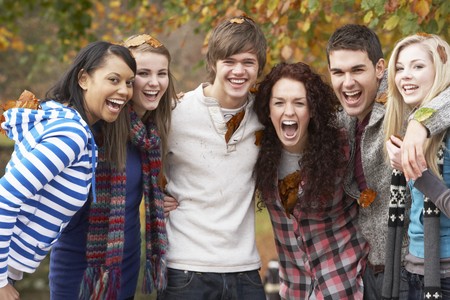 Group Of Six Teenage Friends Having Fun In Autumn Parkの写真素材